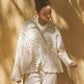 Edit '25 Ayla – an ivory organza shirt with cutwork and scalloped hems. Model poses in this matching pants set, a comfortable Indian festive outfit choice.