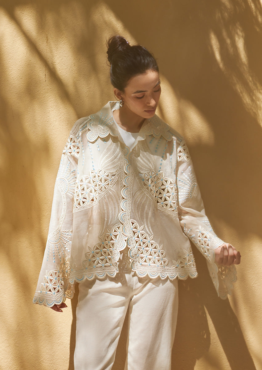 Edit '25 Ayla – an ivory organza shirt with cutwork and scalloped hems. Model poses in this matching pants set, a comfortable Indian festive outfit choice.
